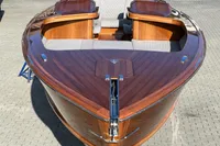 2024 Custom Bowrider boat with sleek wooden finish and modern seating design.