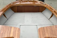 Luxurious 2024 Custom Bowrider boat interior with quilted seating and polished wood finish.