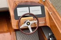2024 Custom Bowrider dashboard with dual Garmin displays and wooden steering wheel.