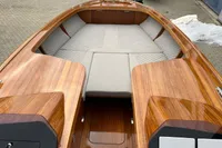 2024 Custom Bowrider with sleek wooden finish and spacious seating area.