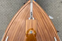 2024 Custom Bowrider boat with sleek wooden deck, top view.