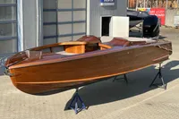 2024 Custom Bowrider boat with sleek wooden finish on display.