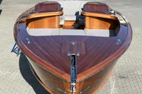 2024 Custom Bowrider boat with sleek wooden finish and comfortable seating.