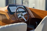 2024 Custom Bowrider dashboard with Garmin displays and wooden steering wheel.