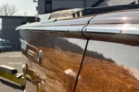 2024 Custom Bowrider boat with polished wood finish and chrome detailing.