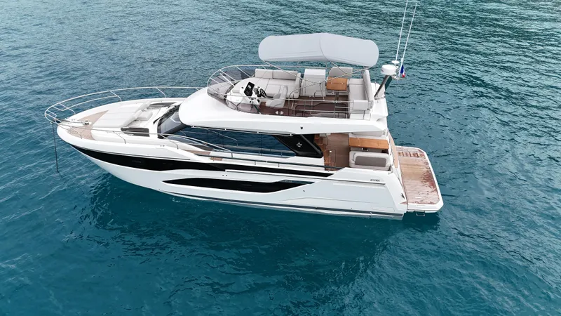 Prestige F4.9 Yacht Photos Pics Luxury 2025 Prestige F4 yacht on clear blue water, showcasing sleek design and spacious deck.