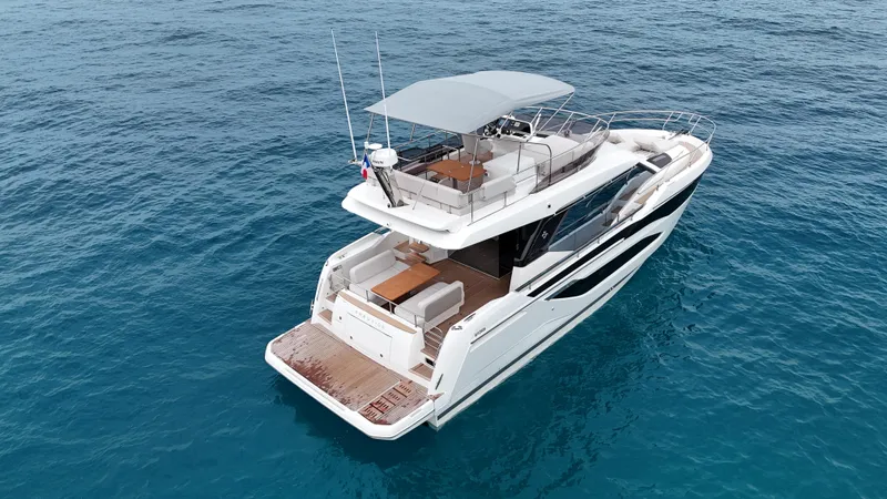 Prestige F4.9 Yacht Photos Pics 2025 Prestige F4 yacht cruising on open blue sea, showcasing sleek design and spacious deck.