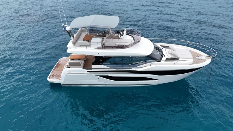 Prestige F4.9 Yacht Photos Pics 2025 Prestige F4 yacht cruising on clear blue ocean waters.