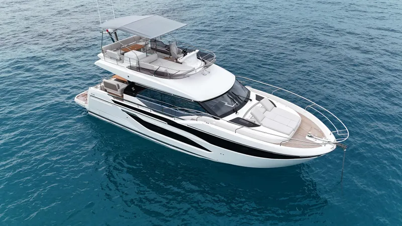 Prestige F4.9 Yacht Photos Pics 2025 Prestige F4 yacht on clear blue water, showcasing sleek design and luxury features.