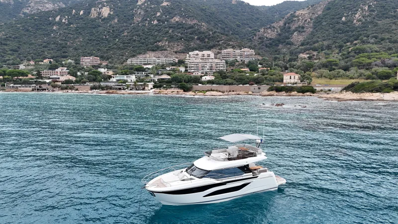 Prestige F4.9 Yacht Photos Pics Luxury Prestige F4 yacht cruising near scenic coastline, 2025 model.