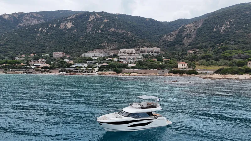 Prestige F4.9 Yacht Photos Pics Luxury Prestige F4 yacht cruising near scenic coastal mountains, 2025 model.