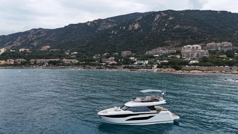 Prestige F4.9 Yacht Photos Pics Luxury Prestige F4 yacht cruising near scenic coastal landscape, 2025 model.