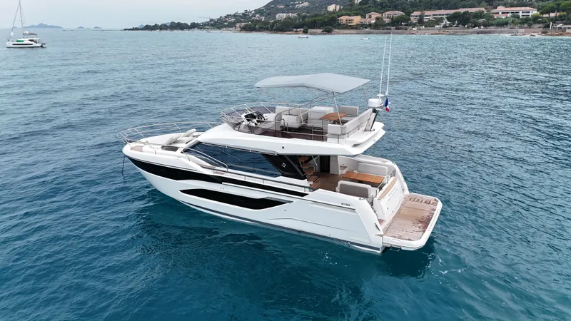 Prestige F4.9 Yacht Photos Pics Luxury 2025 Prestige F4 yacht cruising on clear blue waters.