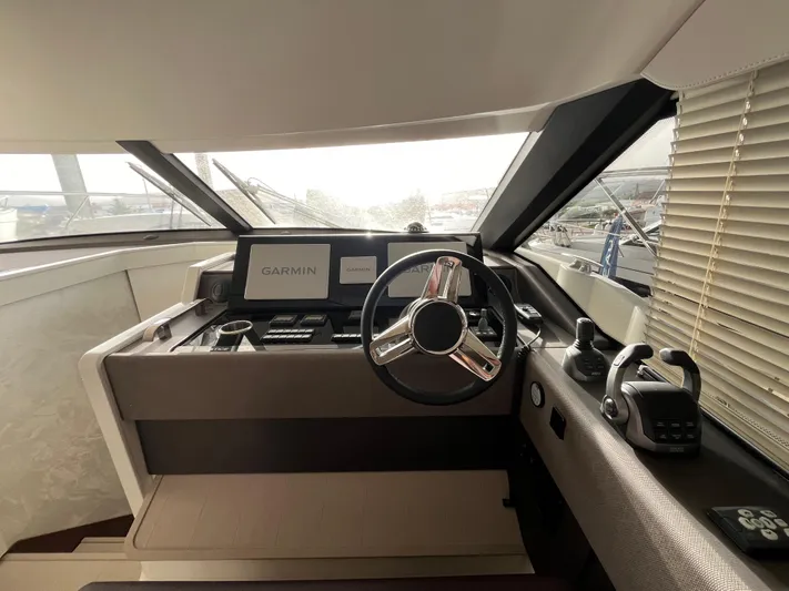 Prestige F4.9 Yacht Photos Pics Helm of 2025 Prestige F4 yacht with Garmin navigation system and modern controls.