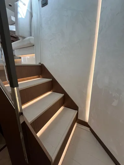 Prestige F4.9 Yacht Photos Pics Modern staircase with ambient lighting in a 2025 Prestige F4 model.