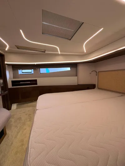 Prestige F4.9 Yacht Photos Pics Luxurious interior of 2025 Prestige F4 yacht with modern lighting and spacious bed.