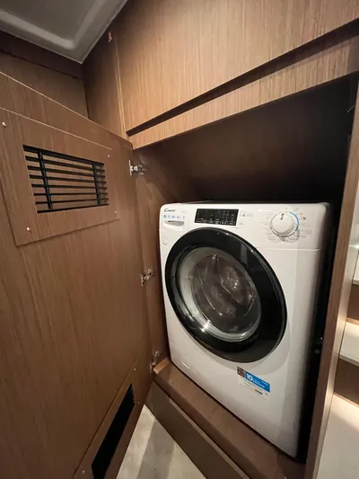 Prestige F4.9 Yacht Photos Pics 2025 Prestige F4 washing machine in a wooden cabinet.