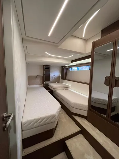 Prestige F4.9 Yacht Photos Pics Luxurious interior of 2025 Prestige F4 yacht with modern lighting and comfortable bedding.