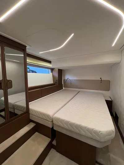 Prestige F4.9 Yacht Photos Pics Luxurious interior of 2025 Prestige F4 yacht with modern lighting and twin beds.