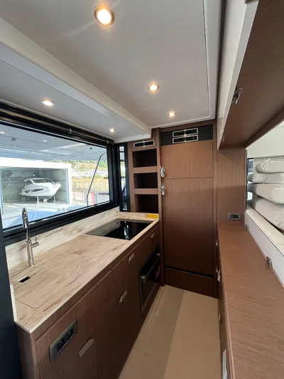 Prestige F4.9 Yacht Photos Pics Modern kitchen interior in 2025 Prestige F4 yacht, featuring sleek wood cabinetry and marble countertops.