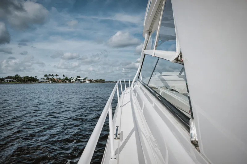  Yacht Photos Pics Intrepid 475 Sport Yacht 2018 cruising on open water under a cloudy sky.