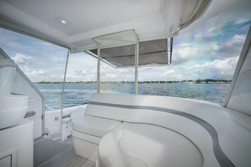  Yacht Photos Pics Intrepid 475 Sport Yacht 2018 interior with seating, overlooking serene water view.