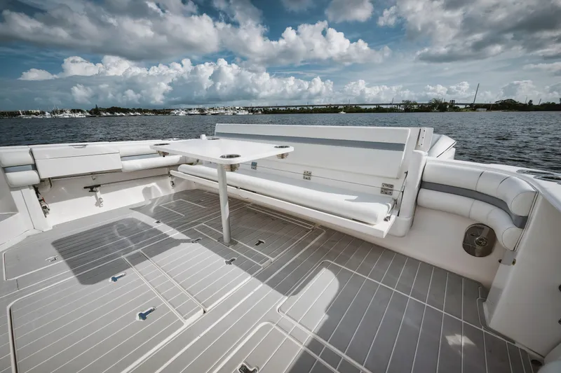  Yacht Photos Pics 2018 Intrepid 475 Sport Yacht deck with seating, table, and scenic water view.