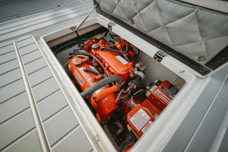  Yacht Photos Pics Engine compartment of a 2018 Intrepid 475 Sport Yacht, showcasing vibrant orange machinery.