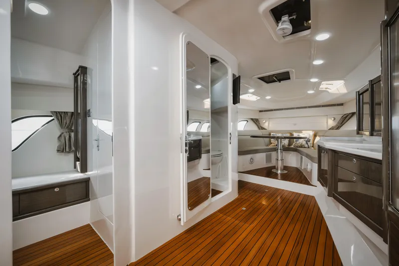  Yacht Photos Pics Luxurious interior of 2018 Intrepid 475 Sport Yacht with sleek design and wooden flooring.