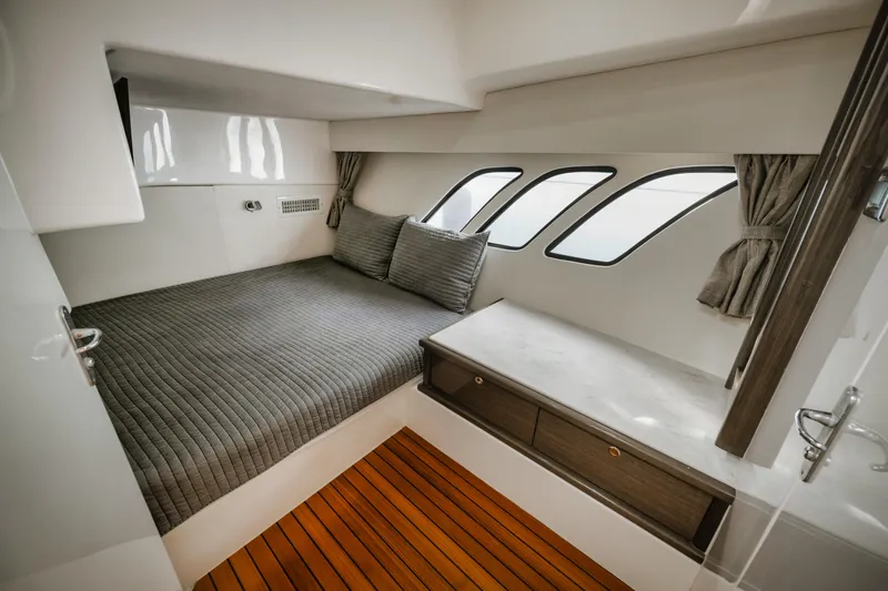  Yacht Photos Pics Luxurious cabin interior of 2018 Intrepid 475 Sport Yacht with modern design and wood flooring.