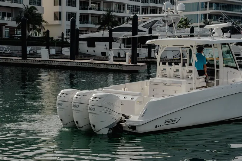  Yacht Photos Pics 2014 Boston Whaler 350 Outrage with triple Mercury engines docked in marina.
