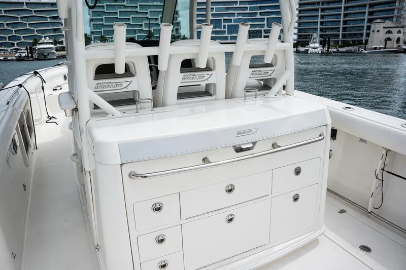  Yacht Photos Pics 2014 Boston Whaler 350 Outrage boat interior with storage and rod holders.