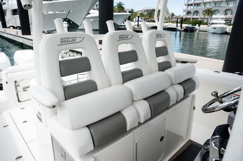  Yacht Photos Pics 2014 Boston Whaler 350 Outrage boat seats, luxurious white and gray design, docked at marina.
