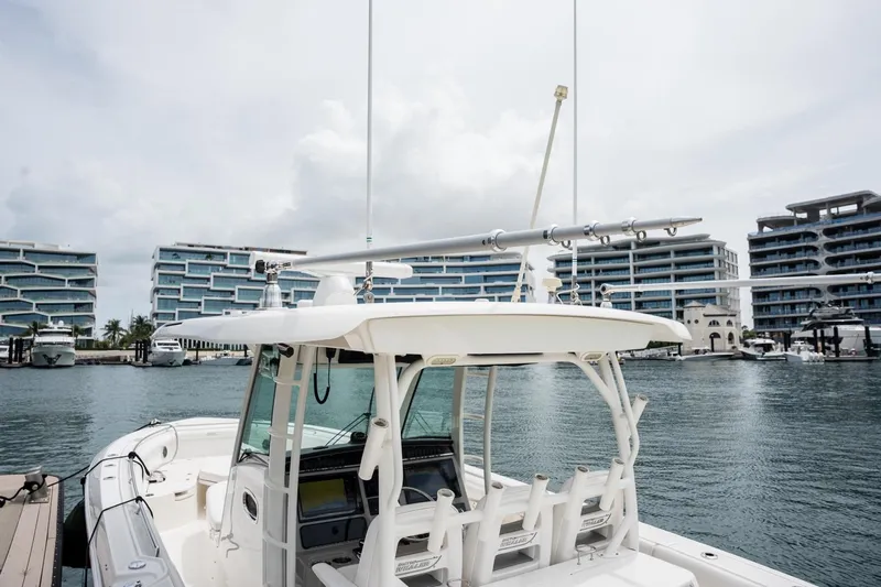  Yacht Photos Pics 2014 Boston Whaler 350 Outrage docked near modern waterfront buildings.