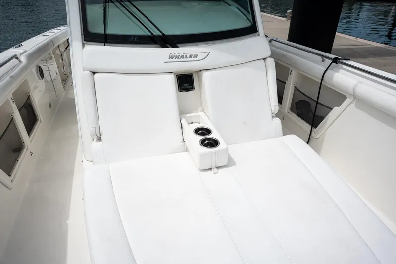  Yacht Photos Pics 2014 Boston Whaler 350 Outrage boat interior with white seating and cup holders.