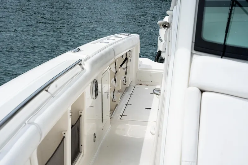  Yacht Photos Pics 2014 Boston Whaler 350 Outrage boat deck with sleek white design on water.