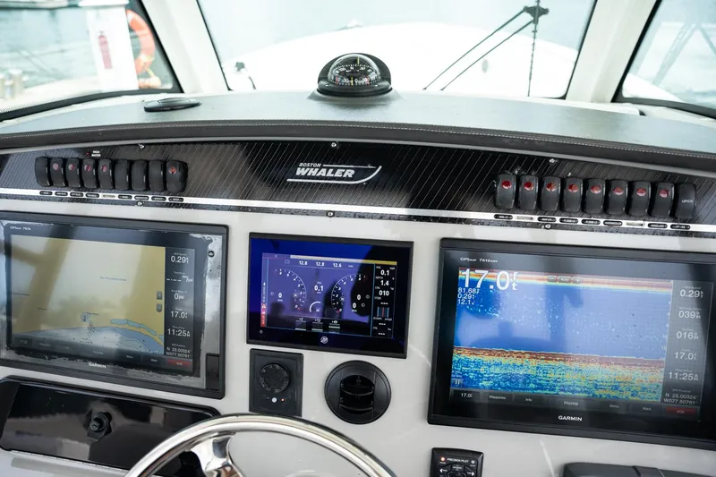  Yacht Photos Pics Dashboard of a 2014 Boston Whaler 350 Outrage with navigation displays.