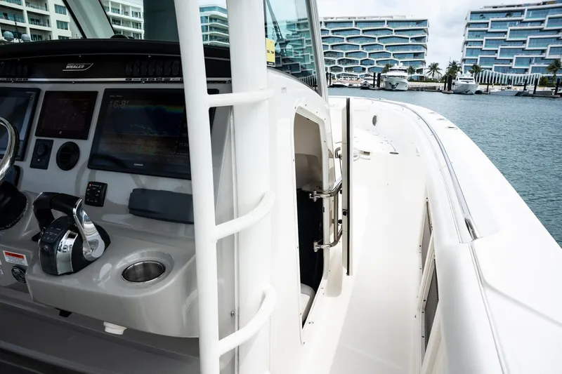  Yacht Photos Pics 2014 Boston Whaler 350 Outrage helm with modern controls, docked near luxury buildings.