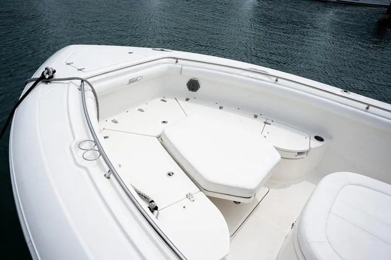  Yacht Photos Pics 2014 Boston Whaler 350 Outrage boat interior with white seating and storage compartments.