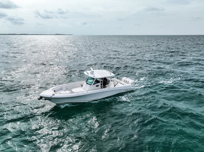  Yacht Photos Pics 2014 Boston Whaler 350 Outrage cruising on open ocean waters.