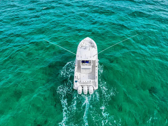  Yacht Photos Pics Aerial view of 2014 Boston Whaler 350 Outrage on turquoise ocean waters.