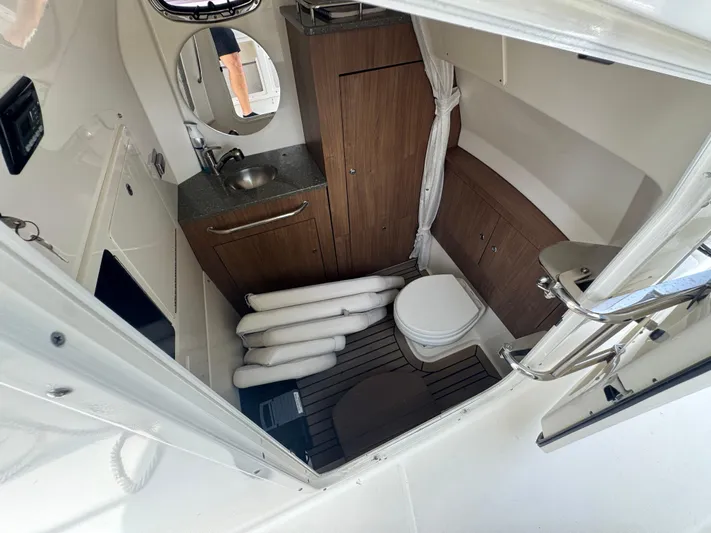  Yacht Photos Pics Interior of 2014 Boston Whaler 350 Outrage boat, featuring a compact bathroom.
