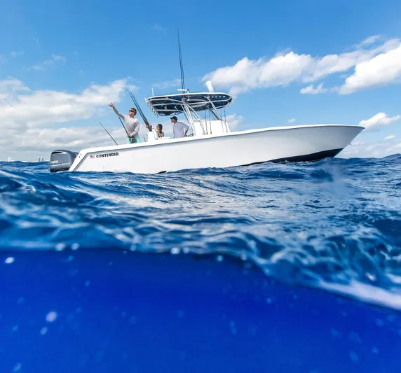  Yacht Photos Pics 2025 Contender 32 ST boat on open water with people fishing.