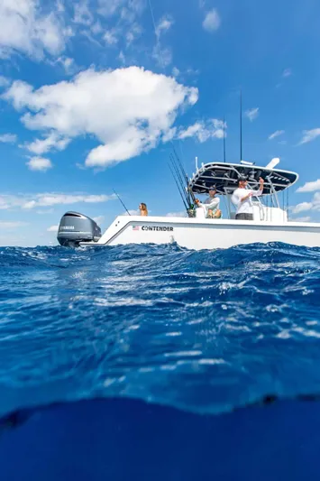  Yacht Photos Pics 2025 Contender 32 ST boat on open water under blue sky.