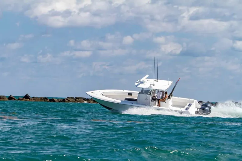  Yacht Photos Pics 2025 Contender 32 ST boat cruising on open water.