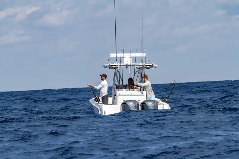  Yacht Photos Pics 2025 Contender 32 ST boat with anglers fishing in open ocean.