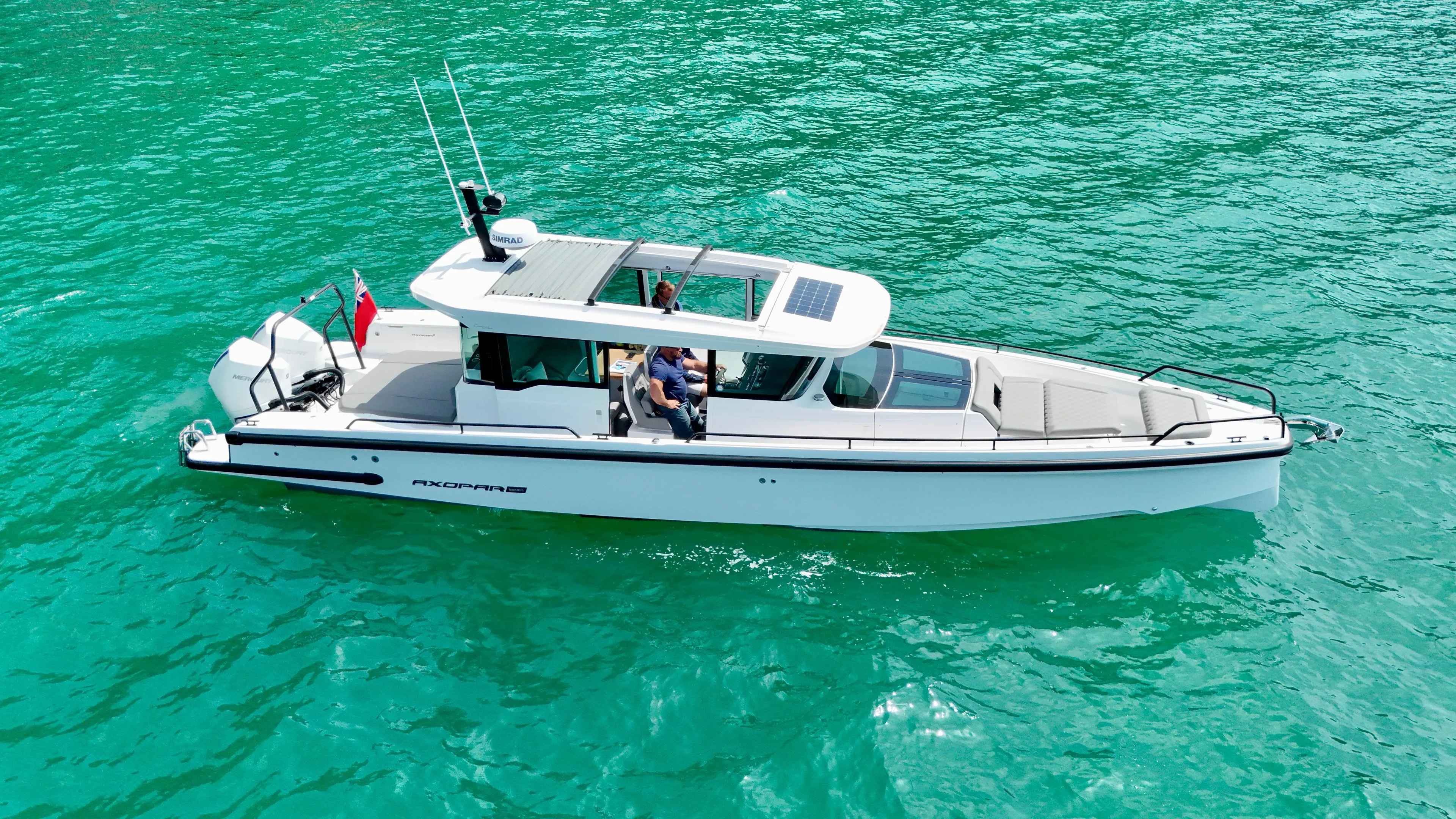 2020 Axopar 37 Cross Cabin boat on turquoise water, featuring multi-storage and JPO joystick.