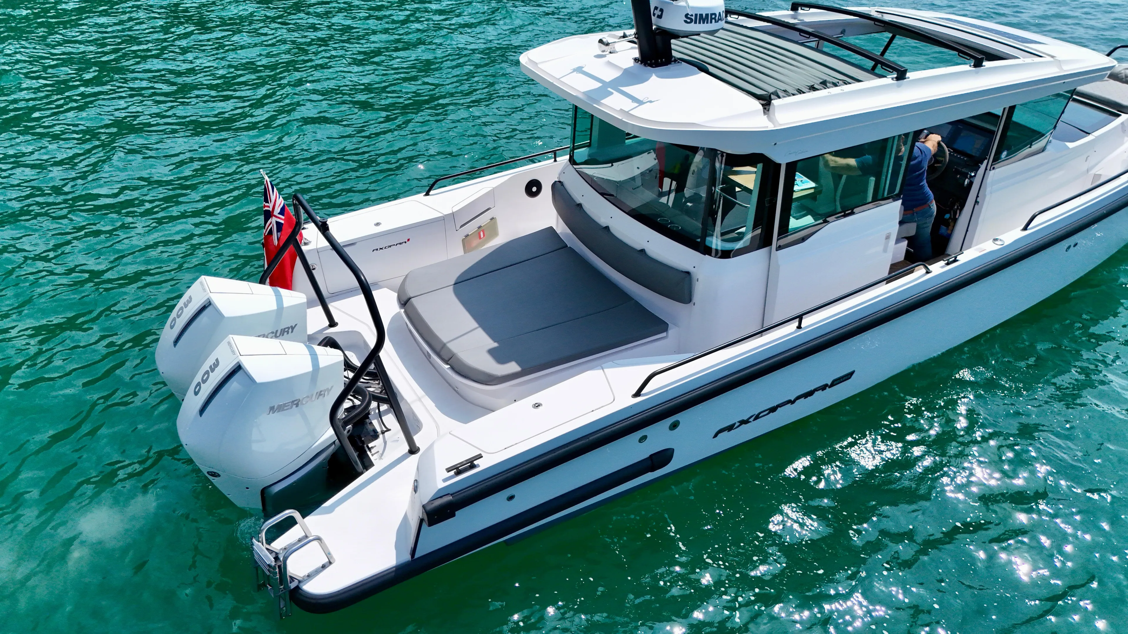 2020 Axopar 37 Cross Cabin boat on clear water, featuring dual Mercury engines.