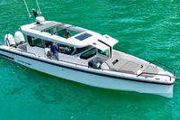 2020 Axopar 37 Cross Cabin boat on turquoise water, featuring multi-storage and JPO joystick.
