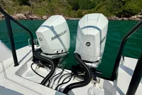 Twin Mercury outboard engines on 2020 Axopar 37 Cross Cabin, scenic lake backdrop.